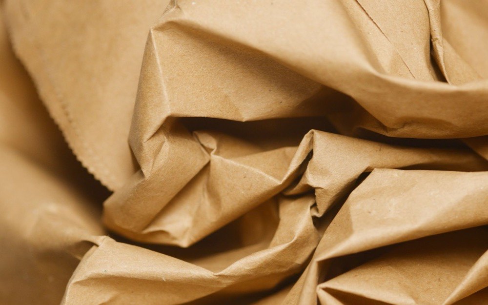 A creased sheet of unbleached kraft paper