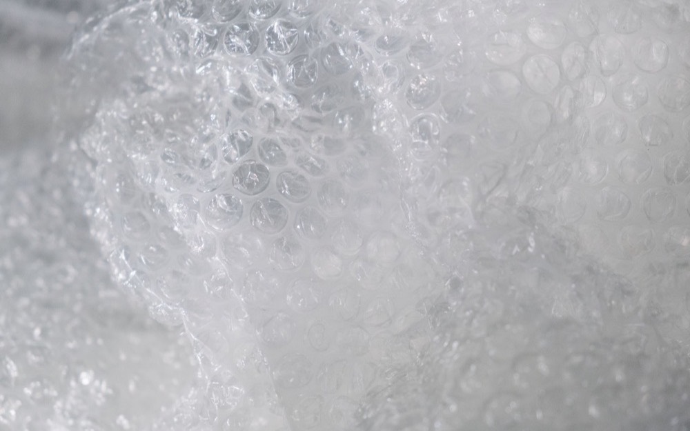 A sheet of clear mono-material film, creased